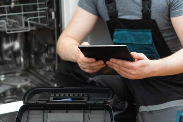 iStock Credit: Dmirtri Maruta An appliance technician with a writing pad